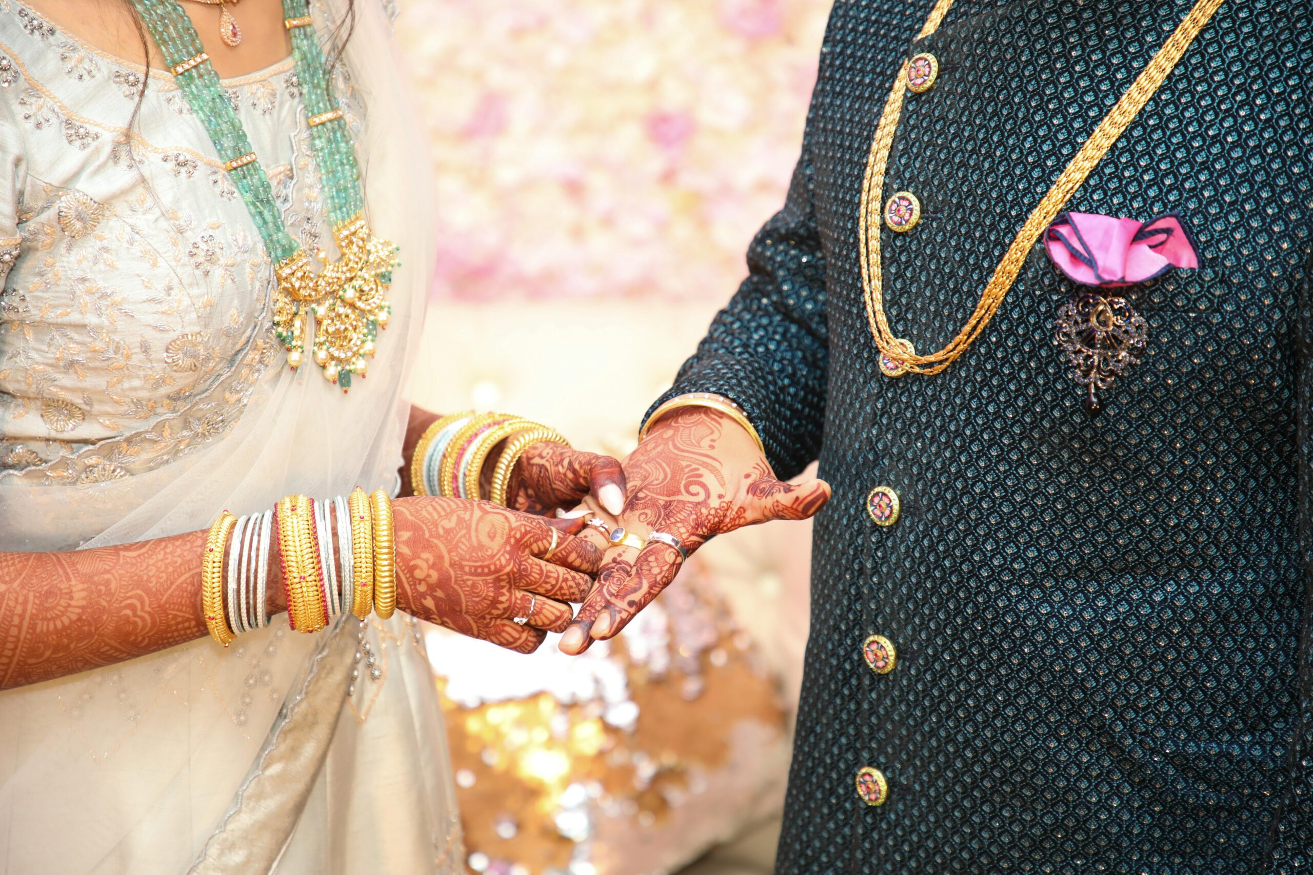 Beautiful moment of a traditional Indian wedding ceremony with stunning jewelry and henna-adorned hands.